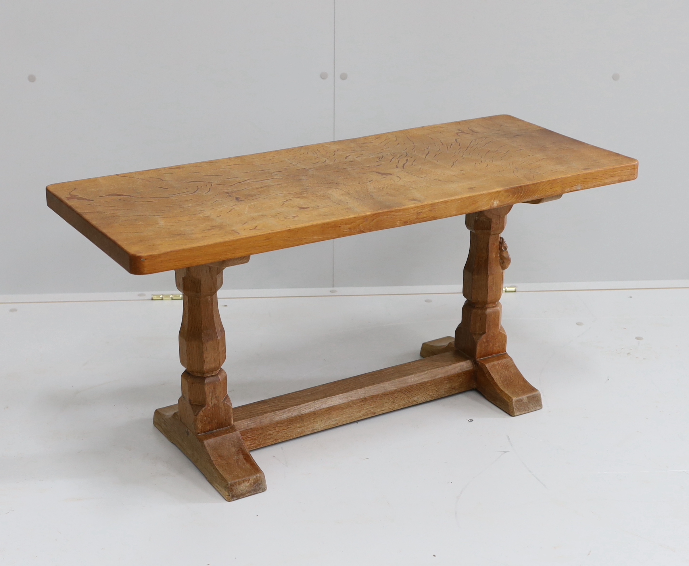 Robert Thompson, The Mouseman, a rectangular oak coffee table with adzed top on octagonal supports, width 91cm, depth 37cm, height 45cm